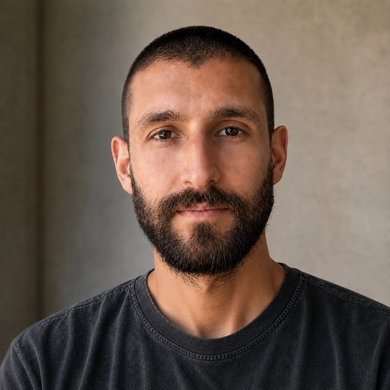 Portrait of Stephan Ryatt wearing a washed black T-shirt against a neutral background.
